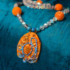 Fashion statement necklace made of clay, spectrolite quartz, dumortierite, fossilized sponge coral and kyanite.
