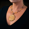 Woman wearing a fashion statement necklace made of clay, jasper, citrine, Czech glass beads. 