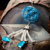 Pendant from a fashion statement necklace made of blue clay, moonstone and shell pearls. with a flower imprint.