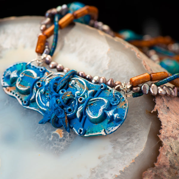 fashion statement necklace made of clay, sea sediment jasper, golden sponge coral, fresh water pearls, and chrysocolla.