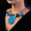 woman wearing fashion statement necklace made of clay, lapis, druzy, and pewter balls.