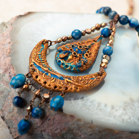 handmade necklace made of clay, lapis, and fresh water pearls.