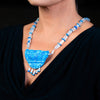 Woman wearing a fashion statement necklace made of clay, Quartz, moonstone and lapis
