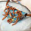 handmade semi precious necklace made of clay, coral, and kyanite.